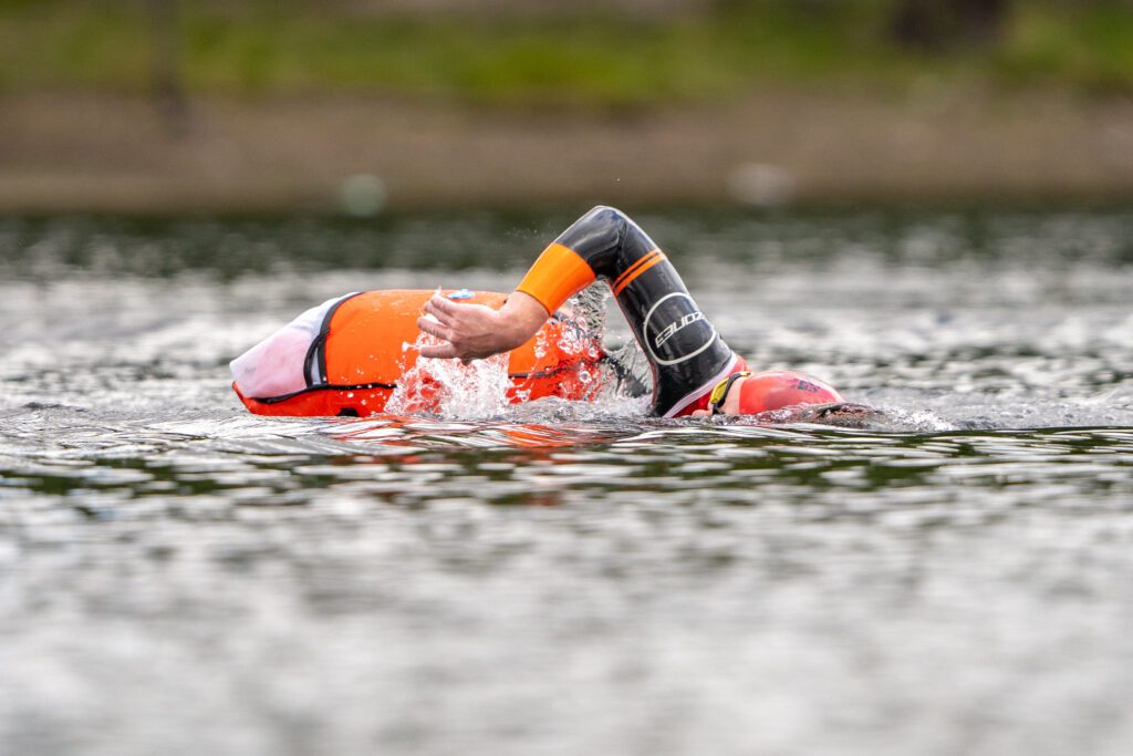 open water swimmer with swimrun tow floats