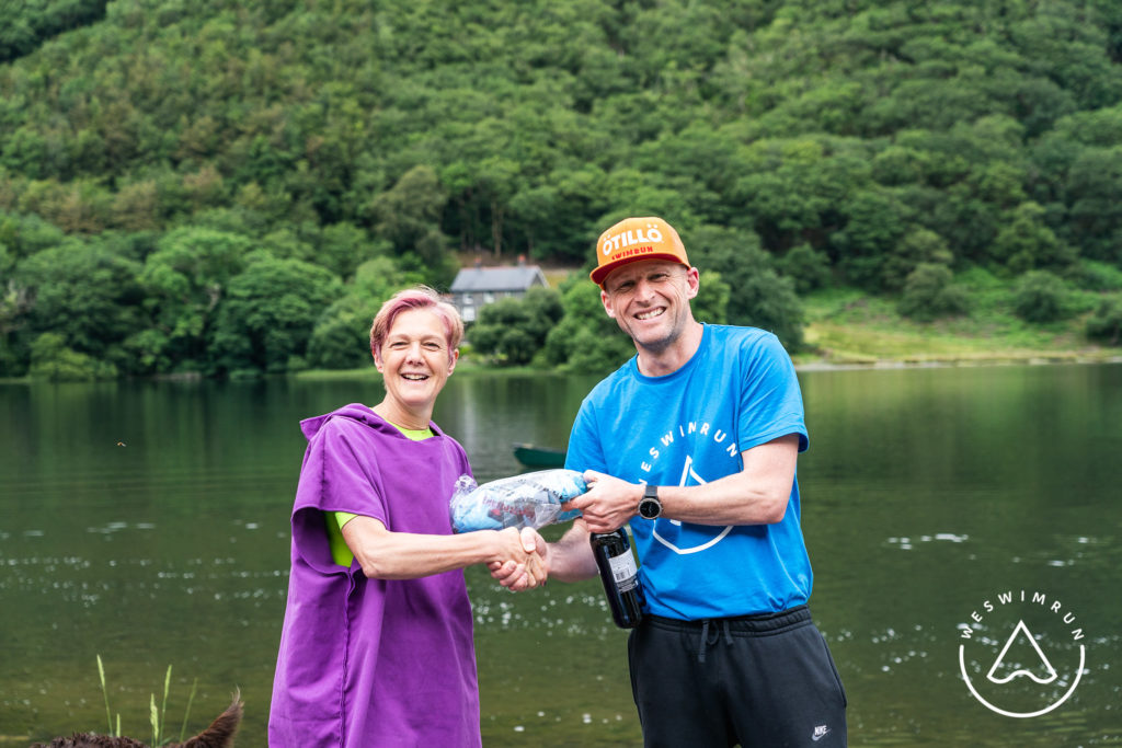 tal y llyn swimrun race director mike alexander shaking hands with participant on shoreline