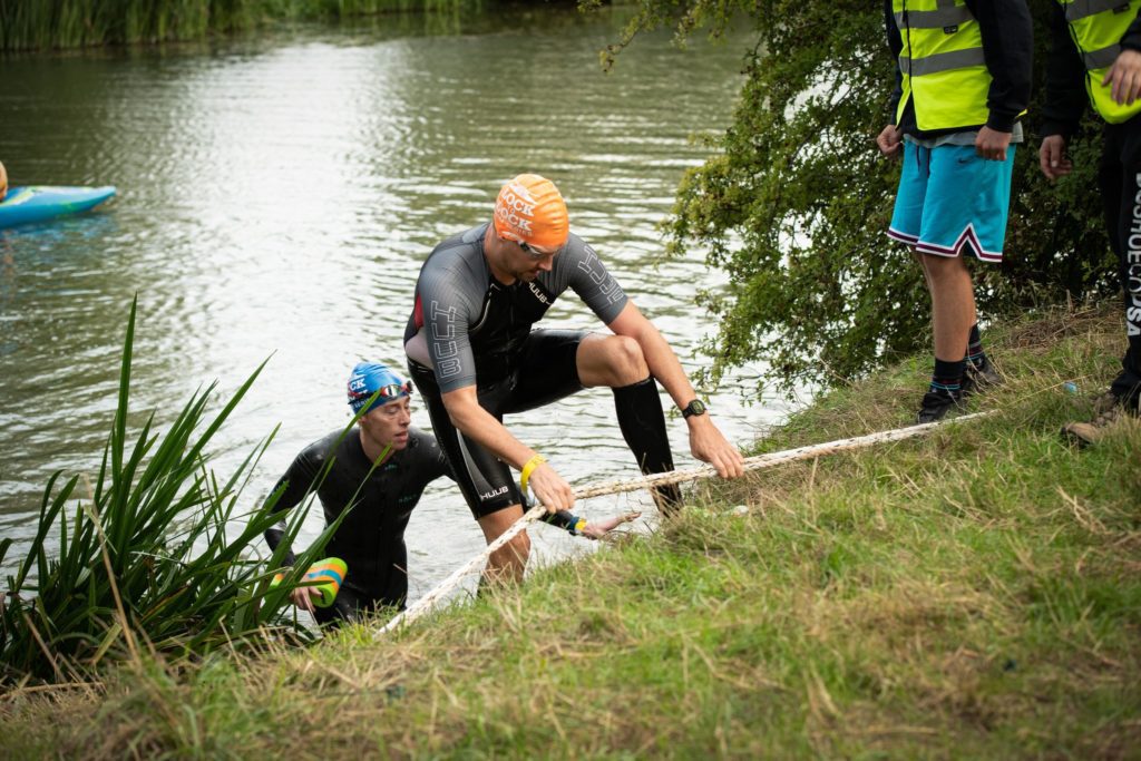 swimrun competitors coming out of the water